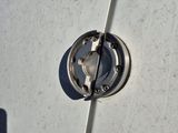 a close up of a metal object on the side of a building