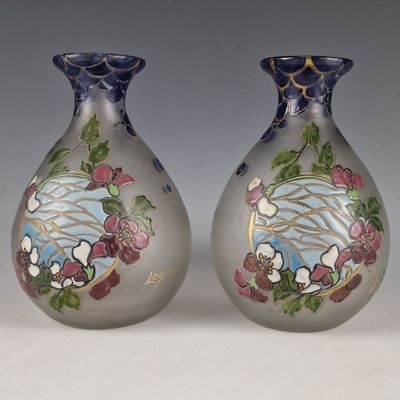 two vases that have been painted with flowers on them