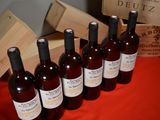 several bottles of wine are lined up on a red table