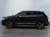 a black bmw suv parked in a room with a white wall