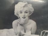 a black and white photo of a woman laying on a bed