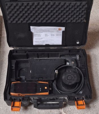 a black case with a tool in it on the floor