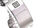 a close up of a watch on a white surface