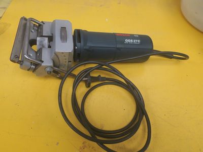 a corded sander on a yellow table