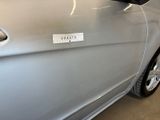 a sticker on the door of a silver car