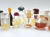 many different types of perfume bottles on a white surface