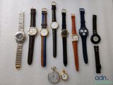 a lot of watches that are sitting on a table