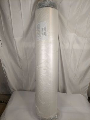 un grand rouleau de papier de soie blanc posé sur un drap blanc