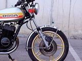 a motorcycle parked in a parking lot with a wall in the background