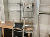 a ladder that is next to a desk in a room