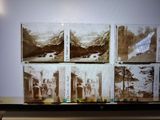 a picture of a man standing in front of a wall with pictures on it
