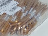 a bag of gold colored umbrellas on a white table