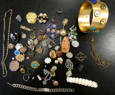 many different types of jewelry on a black table