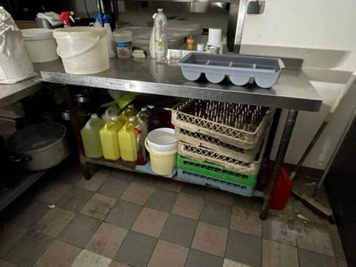 an image of a kitchen with a lot of clutter on the counter