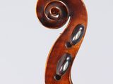 an antique violin with a scroll on the back of it