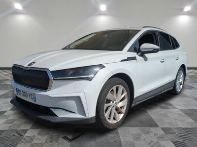 a white car parked in a room with a checkered floor