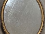 an image of a round mirror sitting on top of a table
