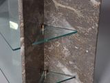 a marble shelf with glass shelves on it