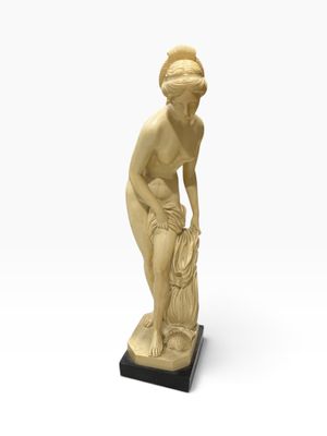 an image of a statue of a woman holding a bag