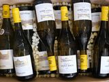 bottles of wine in a cardboard box filled with balls of white wine