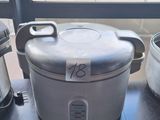 a silver crock pot sitting on a table next to a silver crock pot