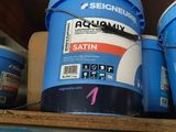 several buckets of paint sitting on top of a shelf in a garage