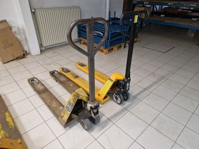 a fork lifter sitting on the floor in a warehouse