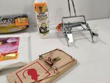 a mousetrage, a bottle of glue, a bottle of glue, and a mousetrage on a table