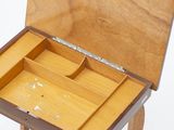 a small wooden box with a drawer on it