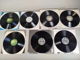 several black and white records sitting on top of a white table