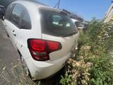 a white car that is parked on the side of the road
