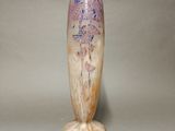 a vase that is sitting on a table with a gray background