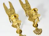 pair of antique brass wall sconces in the shape of a bird