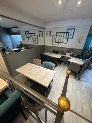 a view of a dining room from the top of the stairs