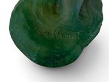 a green sculpture of a woman on a white background