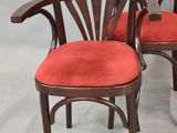 pair of art deco mahogany chairs with red upholstered cushions