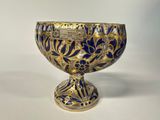 a blue and gold bowl on a white table