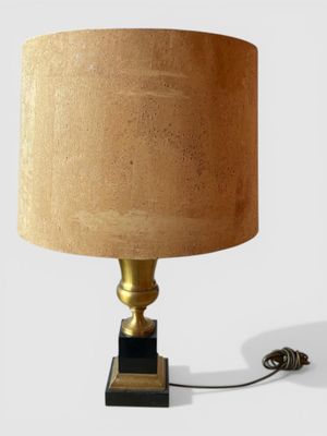 a lamp that is sitting on a table with a lamp shade on it