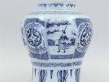 a blue and white vase sitting on a table