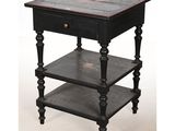 an old black table with three shelves and a drawer on top