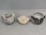 three different types of pottery sitting on a table