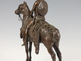 bronze statue of a man on a horse with a shield on his head