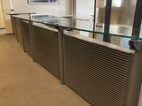 a glass counter in the middle of a large room