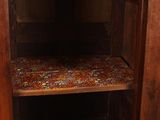 a wooden cabinet with a door open on the floor