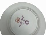 a white plate with a purple and red design on it