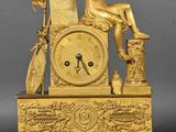 an image of a gold clock sitting on top of a table