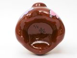 a brown vase with a pink and purple design on it