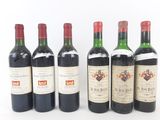 six bottles of wine are lined up in a row on a white surface