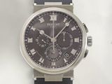 a black watch with roman numerals on the face