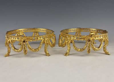 a pair of gold plated candlesticks
